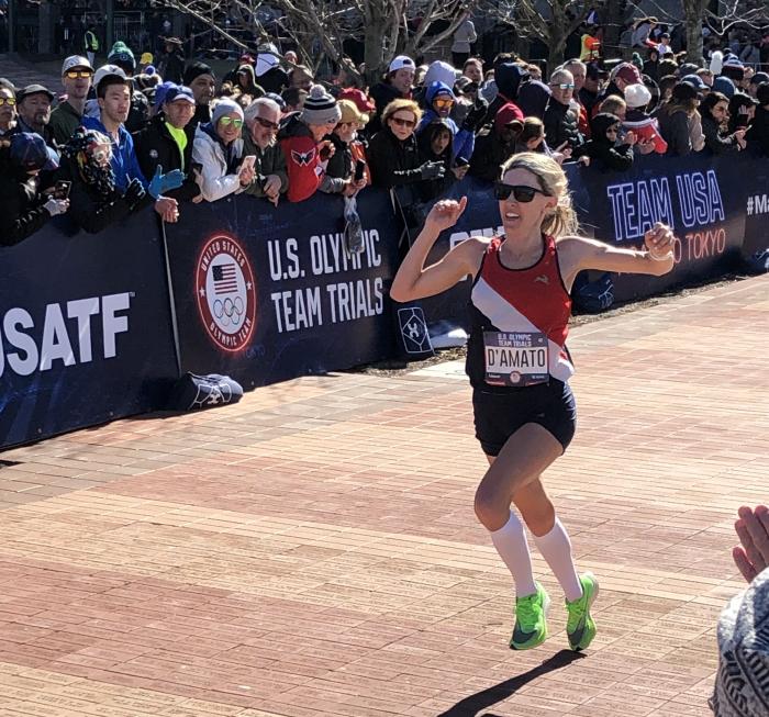 Keira D'Amato celebrates her finish at the 2020 U.S. Olympic Marathon Trials as spectators cheer her to the finish.