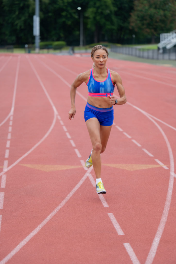 Alisa Harvey running on a track 